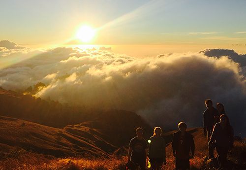 Teens hiking volcano at sunrise on summer camp Bali