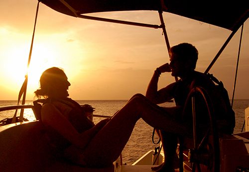 Students on padi instructor training program boat at sunset