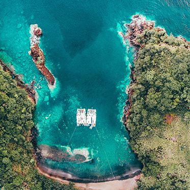 Two Broadreach advanced teen scuba boats anchored in secluded cove Caribbean