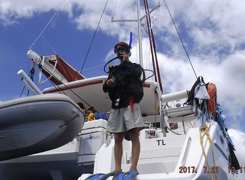 summer sailing camp student jumping into water