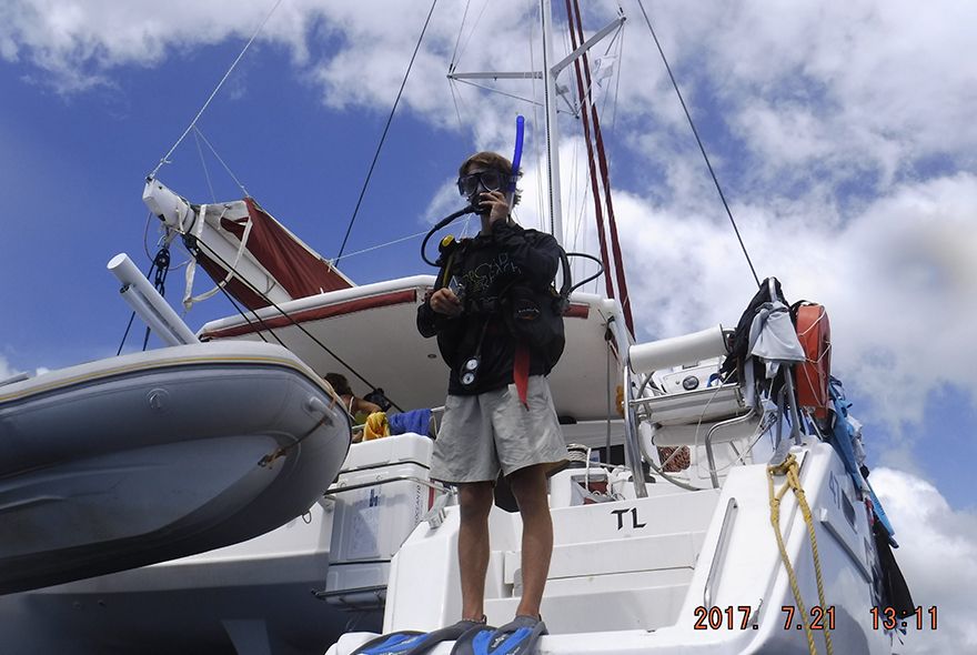 summer sailing camp student jumping into water