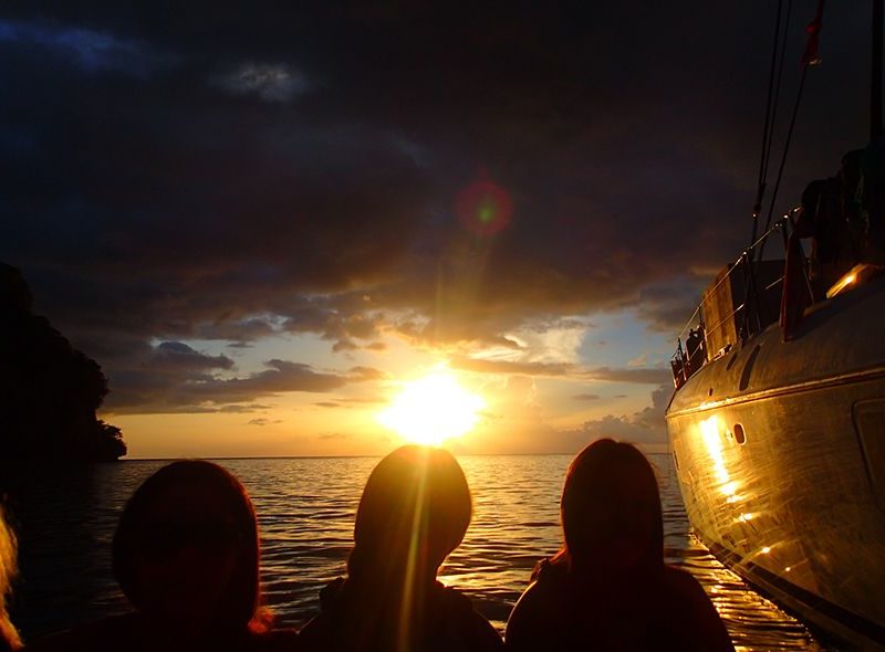 Teens watching Caribbean sunset from Broadreach sailboat