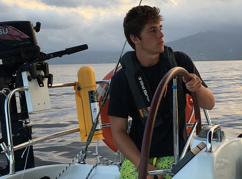 summer sailing program with teen steering boat