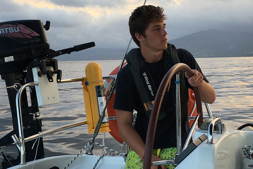 summer sailing program with teen steering boat