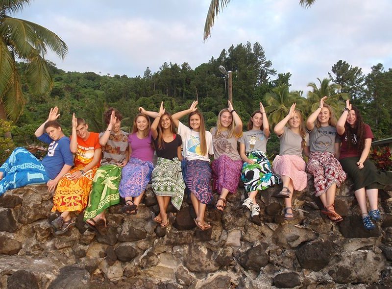 Teens celebrating after diving with sharks on Fiji summer camp