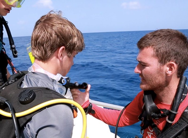Dive buddies checking gear on summer padi owsi course camp