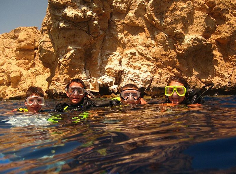 Teens diving in red sea on scuba summer camp