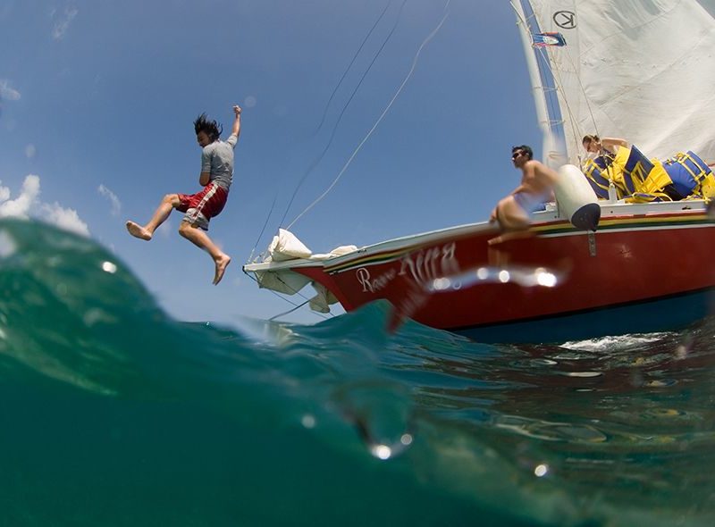 Student jumping into ocean from Broadreach Caribbean sail boat