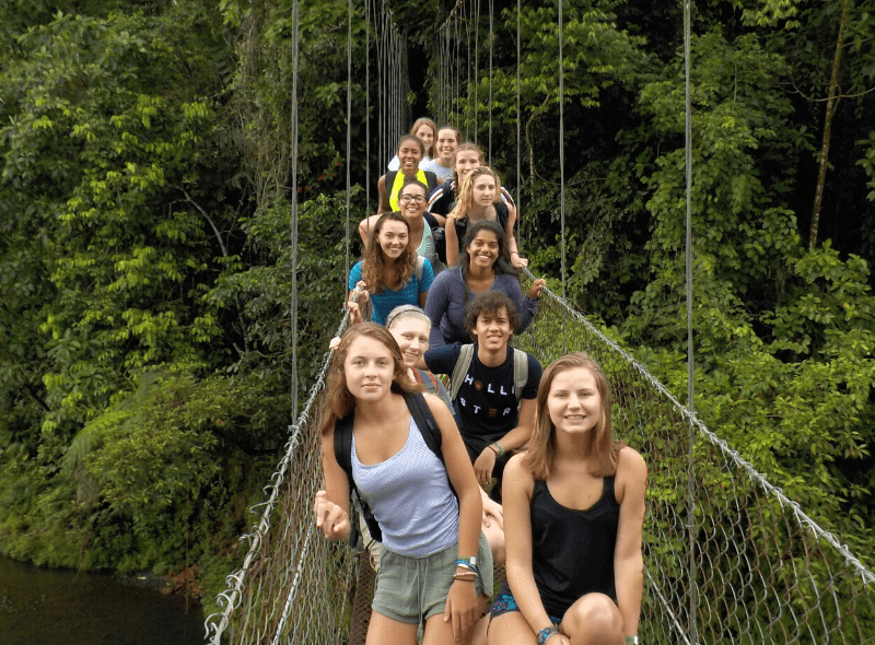 Group of teens on hanging bridge in Costa Rica