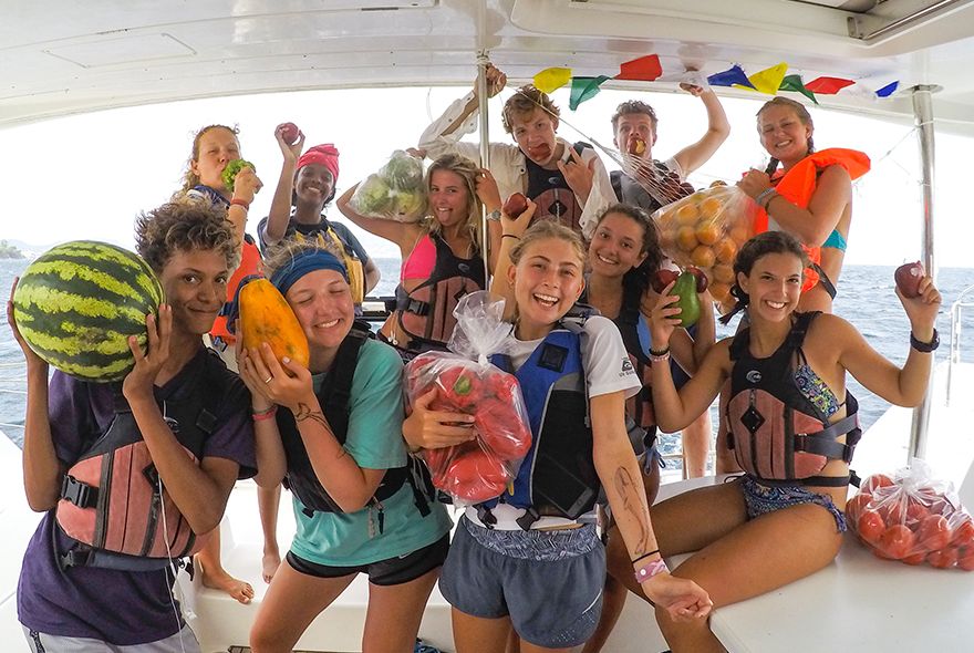 Teens with tropical fruits from local market Nevis Caribbean camp