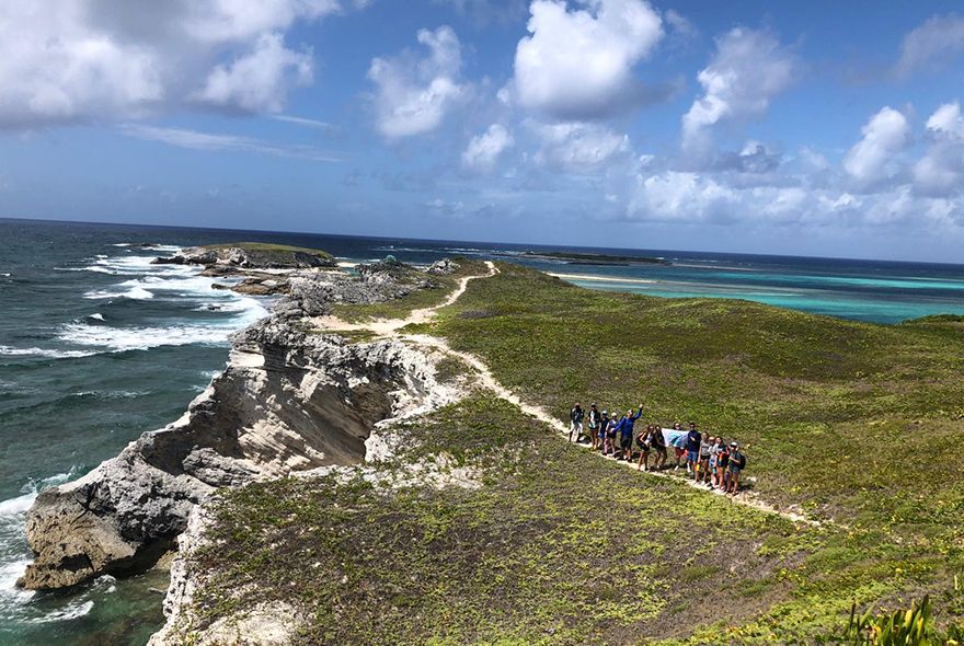 Students hiking on marine biology summer program for teens