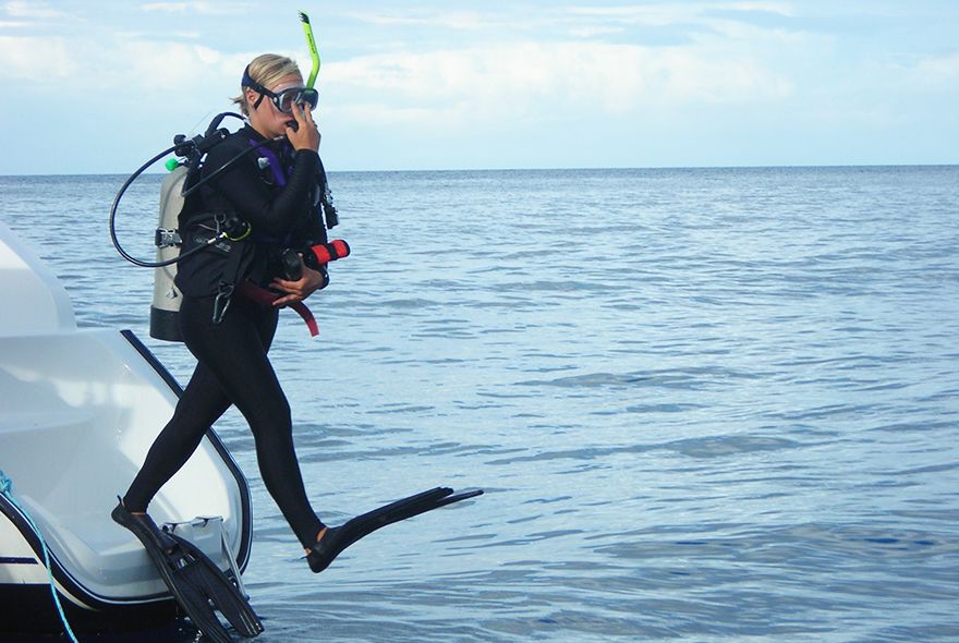 Diver jumping into sea on diving internships Caribbean