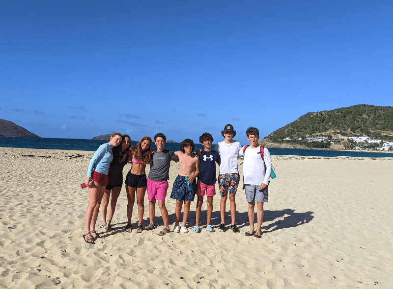 Middle school students on Caribbean beach at scuba and sailing camp