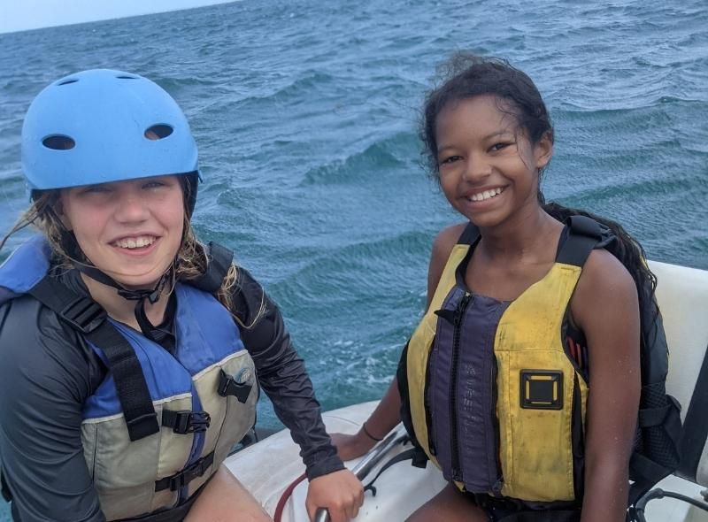 Middle school girls preparing to do water sports on marine biology summer camp