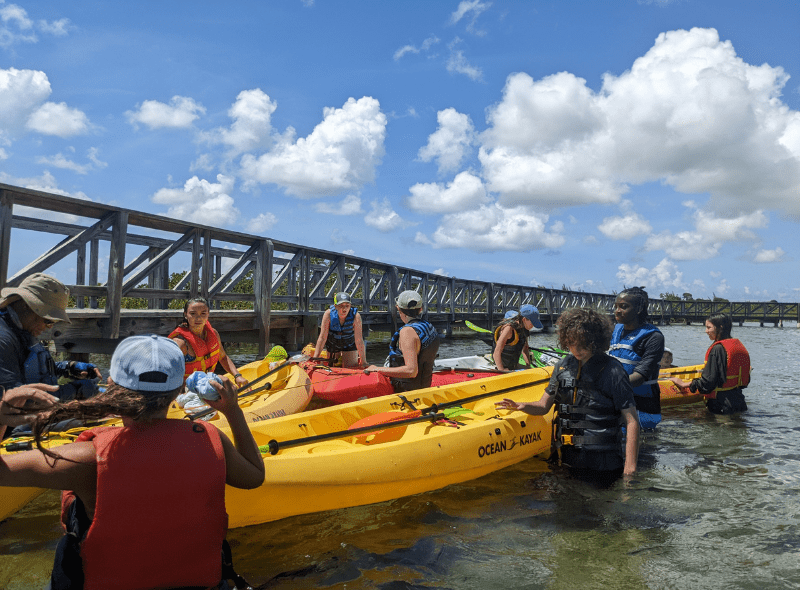 Group of teens kayak in Bahamas at animal science camp