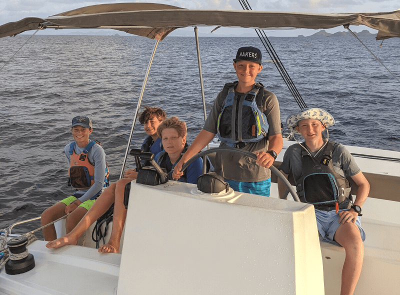 Middle school students sail catamaran during summer scuba and sailing program