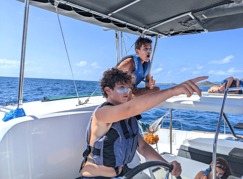 Two middle school students sail catamaran on advanced dive trip