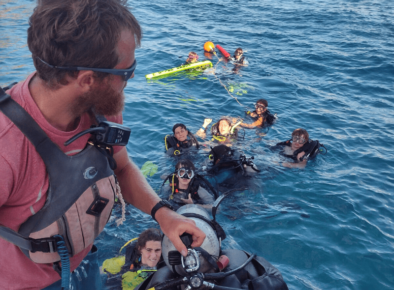 Middle school students dive off boat on advanced scuba trip to Caribbean windward islands