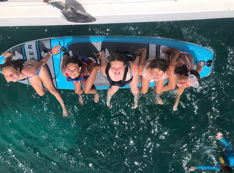 middle school students on paddleboard in Caribbean on scuba camp