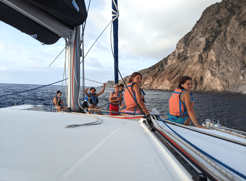Middle school students on catamaran at advanced dive and sail program