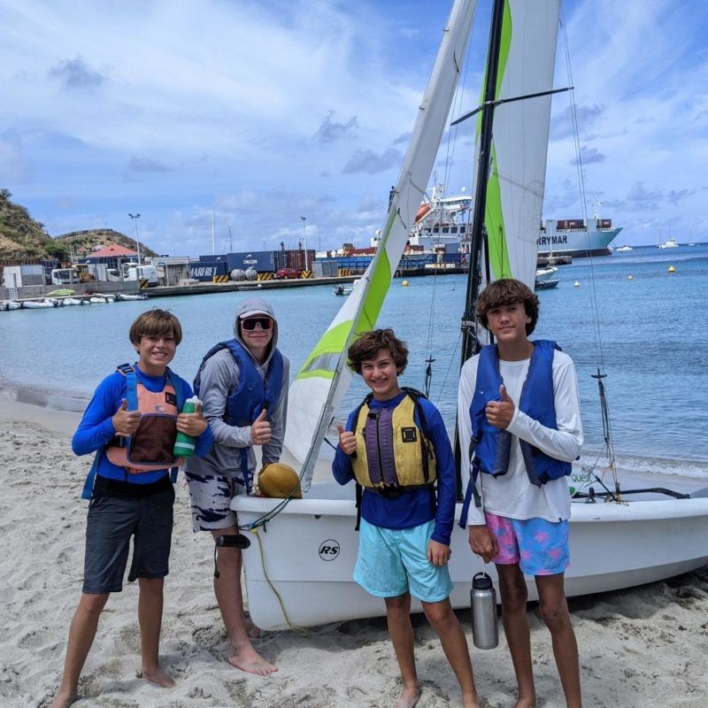 Middle school boys pose with dinghy at Caribbean summer sailing camp