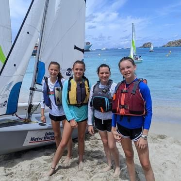 group of middle school students with boat at sailing camp