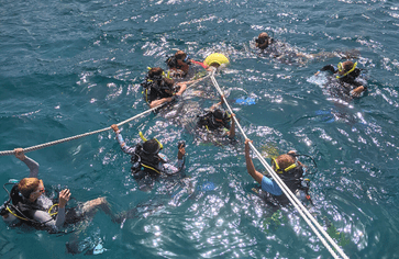 Middle school students scuba diving in Caribbean on dive and sail camp