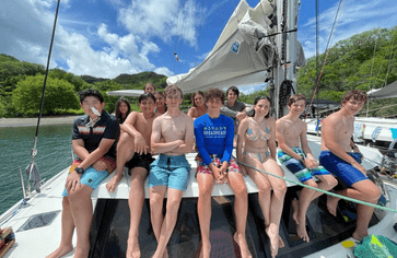 Middle school students on catamaran for advanced scuba voyage