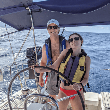 High school student and instructor at helm of monohull on sailing program