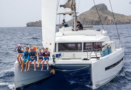 Middle school students on catamaran for intro to marine biology program