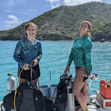 Teens prepare scuba gear aboard catamaran on Caribbean dive program