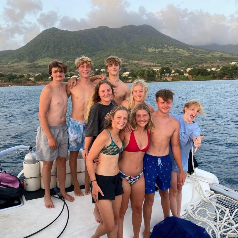 Group of high school students on sailboat during summer scuba and sailing voyage