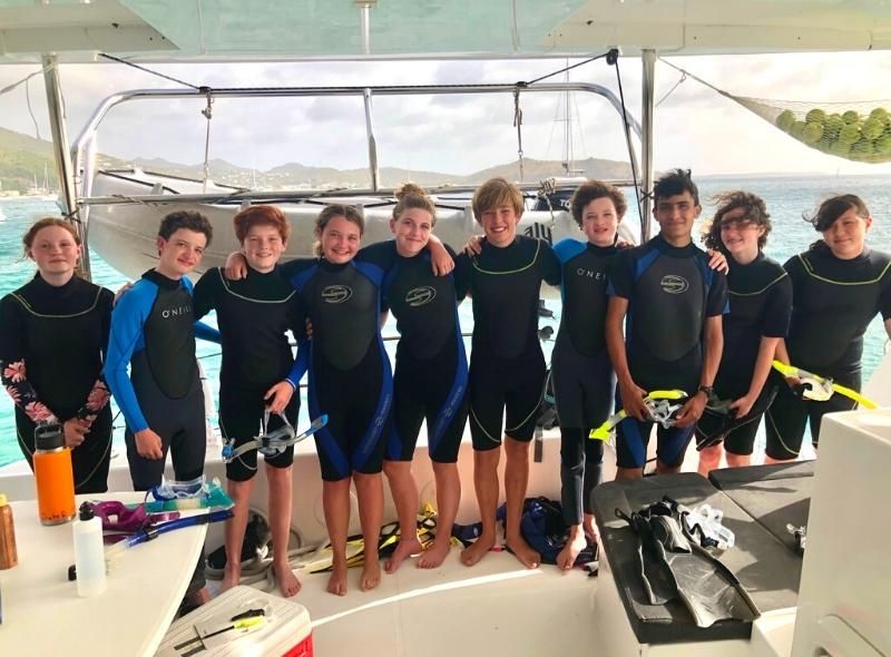Middle school students in scuba gear on catamaran during dive program