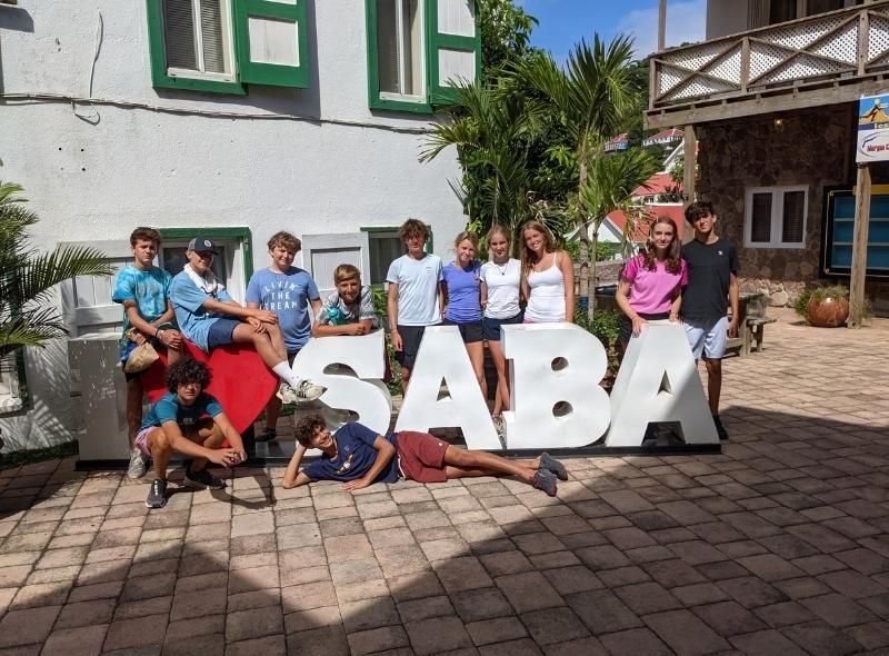 Middle school students pose with Saba sign during Caribbean summer program