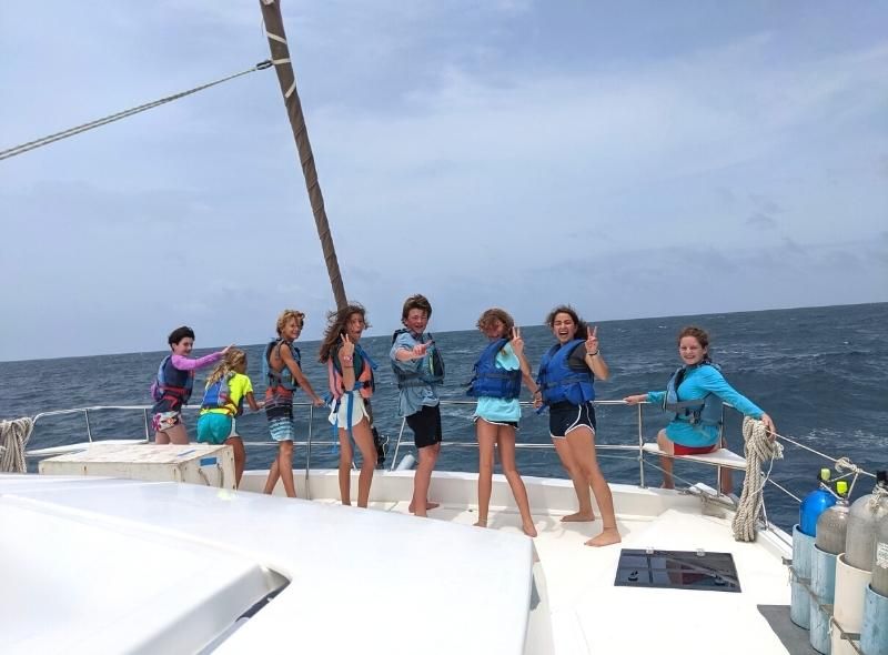 Middle school students at bow of boat on summer dive trip