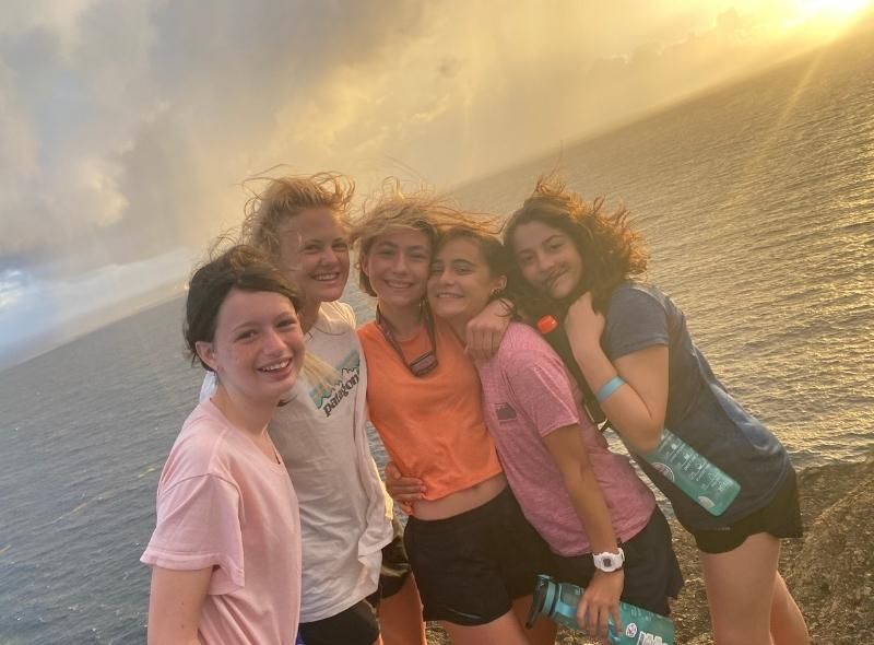 Group of middle school students explore island at sunrise during summer scuba program