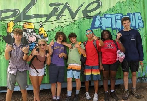 High school students pose on Caribbean island during advanced sailing summer camp