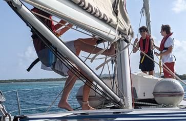 Teens sailing monohull through Caribbean on advanced sailing summer program