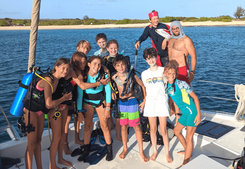 Teens in scuba gear after dive at Caribbean scuba and sailing camp
