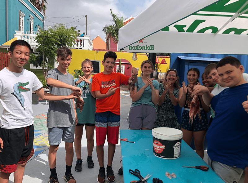 Middle school students on marine biology summer camp volunteer at coral nursery