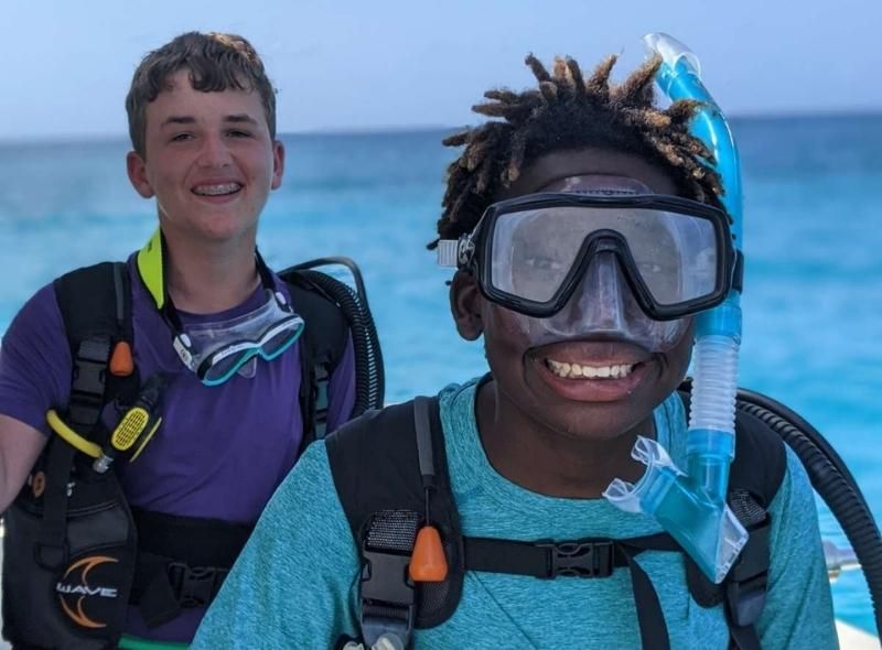 Two middle school boys in scuba gear on marine biology summer program for middle school students