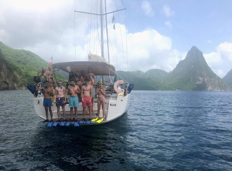 Group of teens snorkel during summer sailing camp