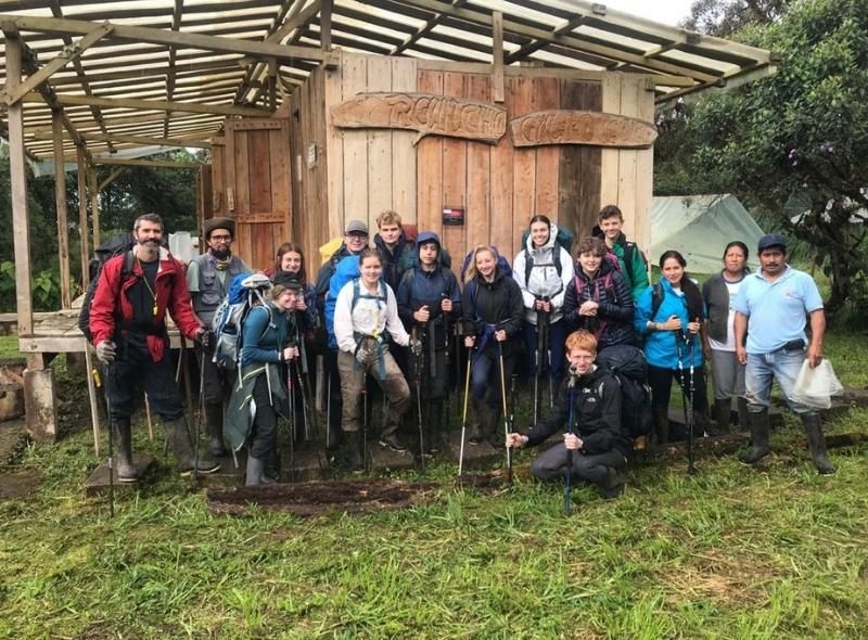 Group of high school students prepare to hike through Amazon rainforest on wildlife biology program