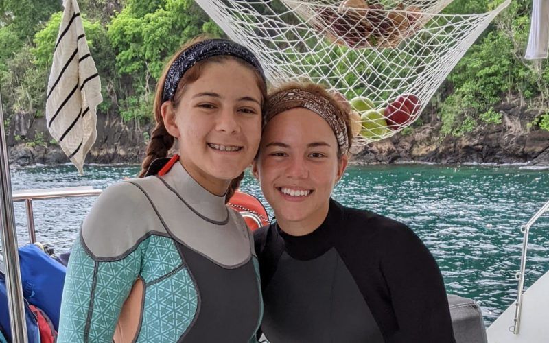 Teenagers in wetsuits on advanced scuba diving summer program