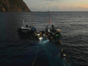 Teens begin night dive as a part of Advanced Open Water course on Broadreach Caribbean trip