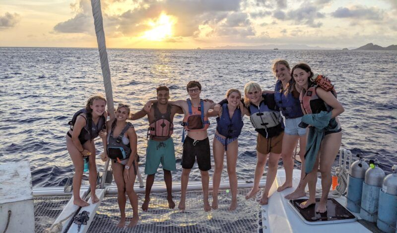 High schoolers on sailboat during marine biology summer camp