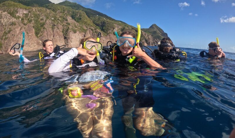 Teen high school students in scuba gear at surface of Caribbean for 12 day dive and sail program