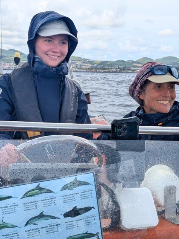high school student helps steer whale watching boat on whale and dolphin marine biology program