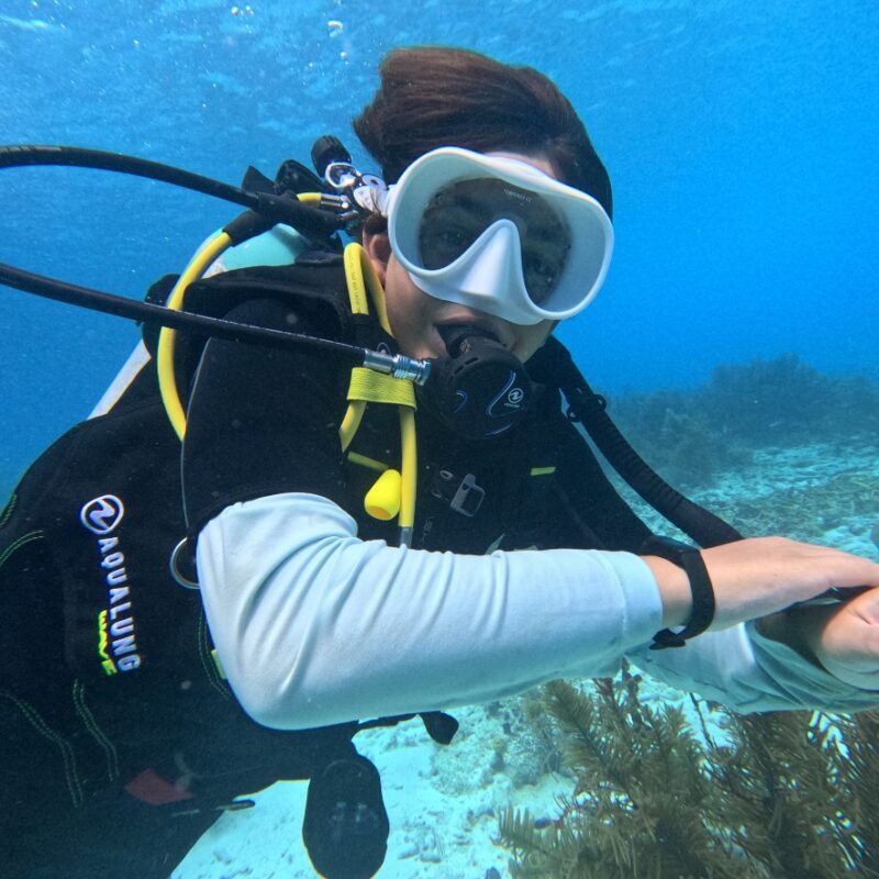 Middle school scuba diver dives with colorful coral in Bonaire