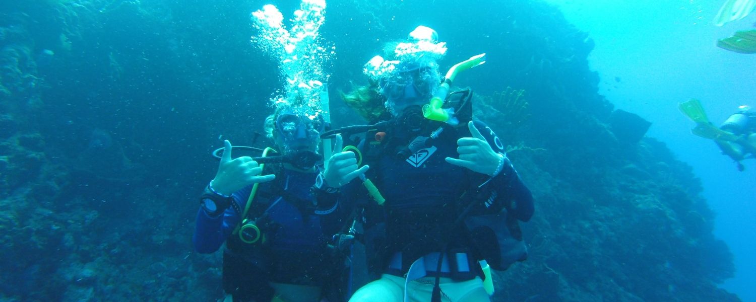 high school students scuba dive underwater in the Caribbean on dive and sail summer program